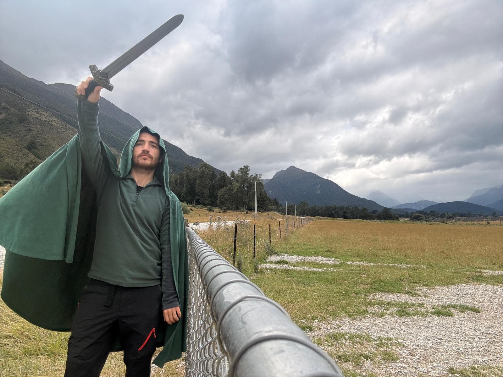 Orcun with sword in NZ countryside